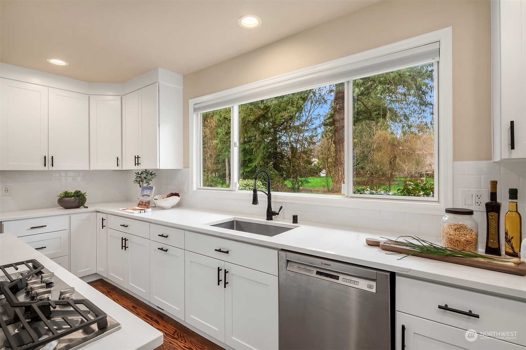 15425 192nd Court Northeast Woodinville, WA 98072 - Photo 11 of 33 a kitchen with a sink stove and cabinets