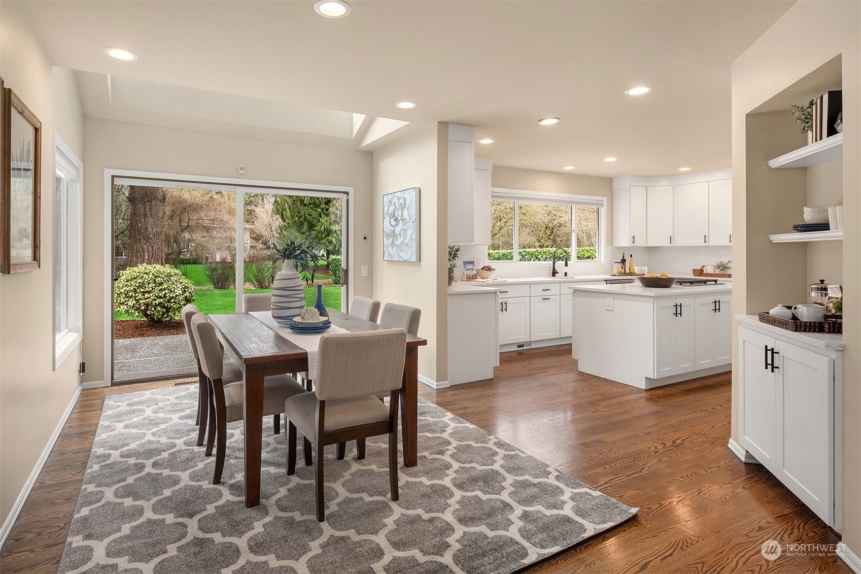 15425 192nd Court Northeast Woodinville, WA 98072 - Photo 15 of 33 a kitchen with kitchen island a table and chairs in it