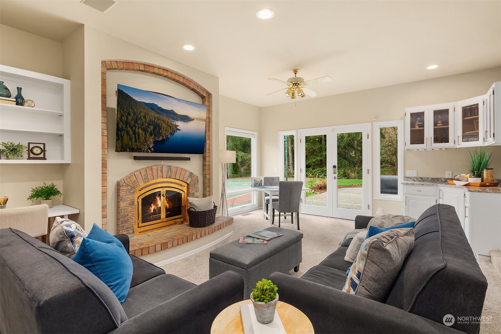 15425 192nd Court Northeast Woodinville, WA 98072 - Photo 16 of 33 a living room with furniture a fireplace and a flat screen tv