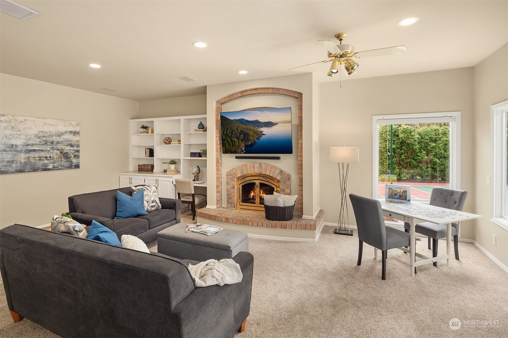 15425 192nd Court Northeast Woodinville, WA 98072 - Photo 18 of 33 a living room with furniture a fireplace and a flat screen tv