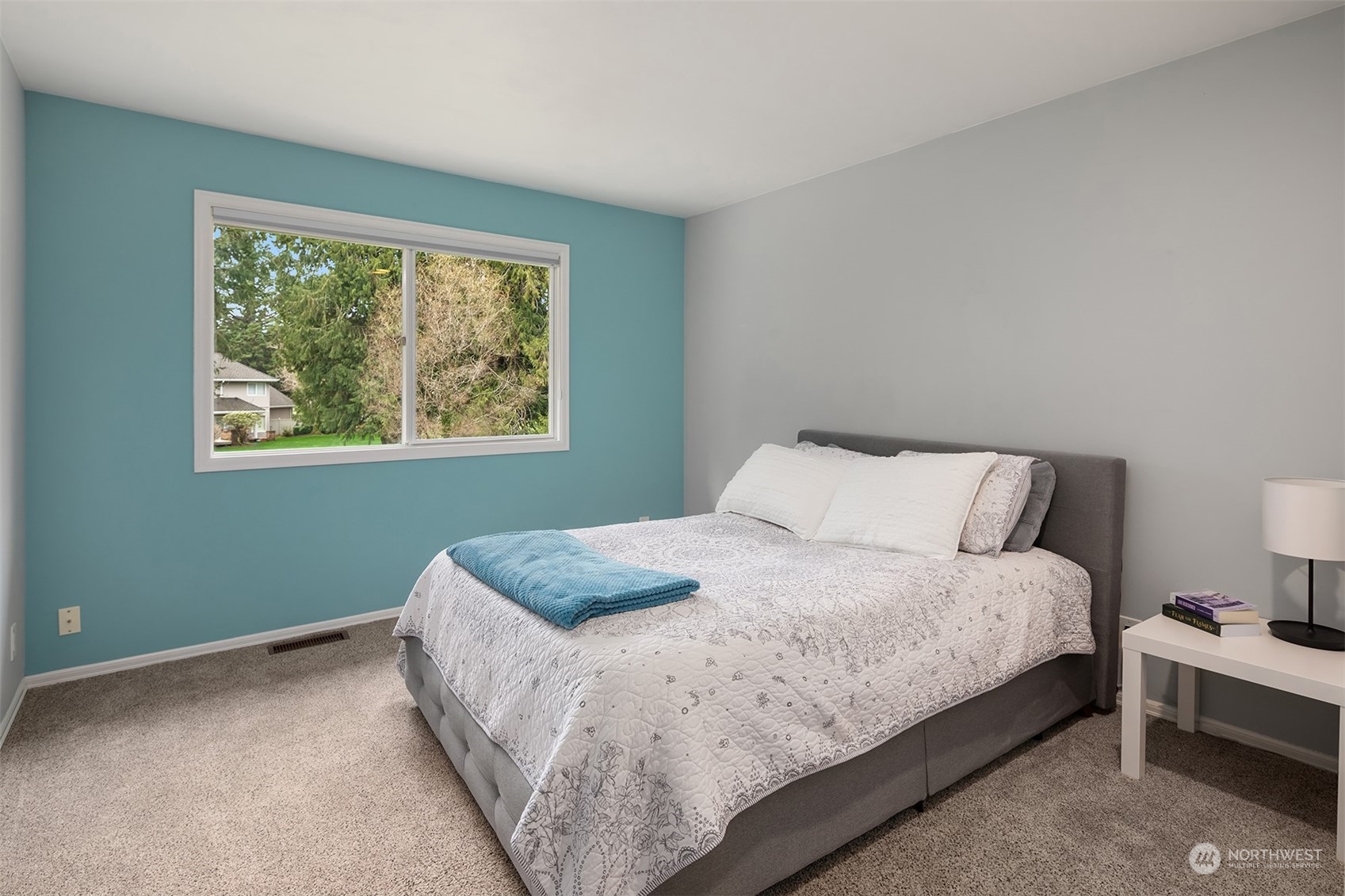 15425 192nd Court Northeast Woodinville, WA 98072 - Photo 30 of 33 a large bed sitting in a bedroom next to a window