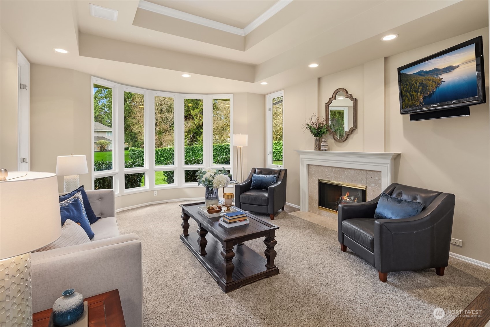 15425 192nd Court Northeast Woodinville, WA 98072 - Photo 6 of 33 a living room with furniture a flat screen tv and a fireplace