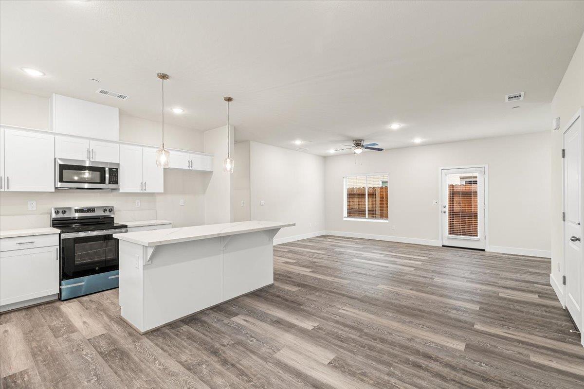 1415 Villa Way Modesto, CA 95351 - Photo 16 of 37 a large kitchen with stainless steel appliances granite countertop a large counter top and a stove top oven