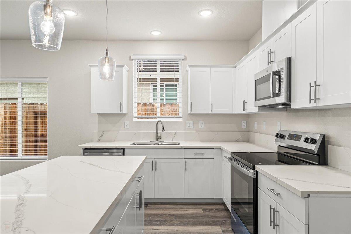 1415 Villa Way Modesto, CA 95351 - Photo 18 of 37 a kitchen with stainless steel appliances granite countertop a sink a stove and cabinets