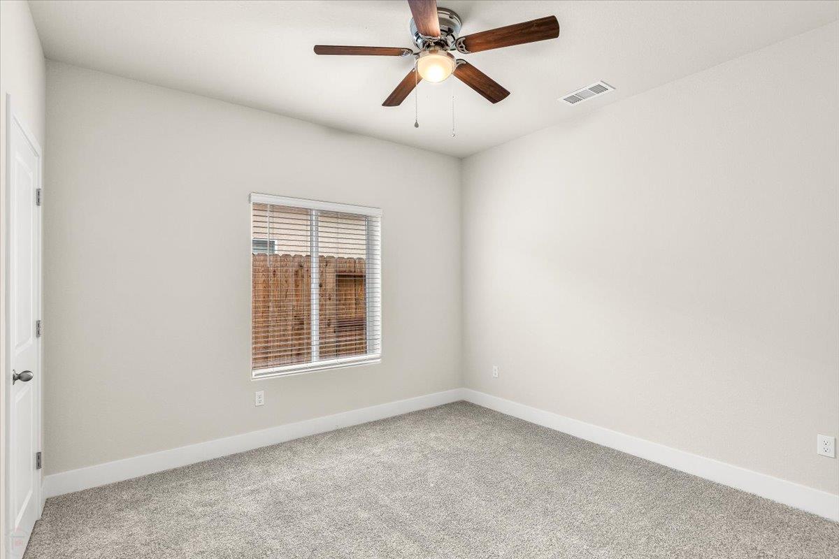 1415 Villa Way Modesto, CA 95351 - Photo 21 of 37 an empty room with a window and a fan