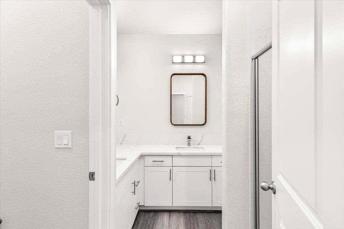 1415 Villa Way Modesto, CA 95351 - Photo 31 of 37 a bathroom with a toilet sink vanity and mirror