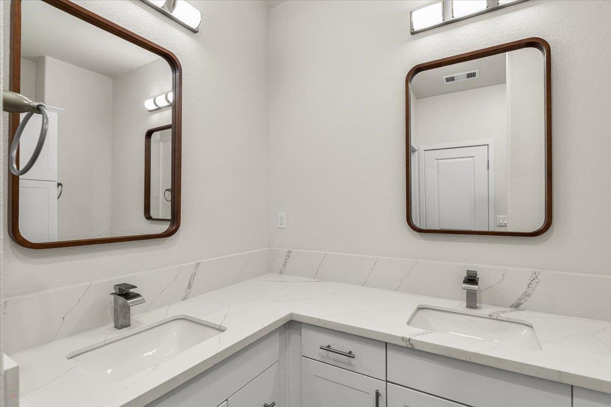 1415 Villa Way Modesto, CA 95351 - Photo 34 of 37 a bathroom with a sink vanity and mirror