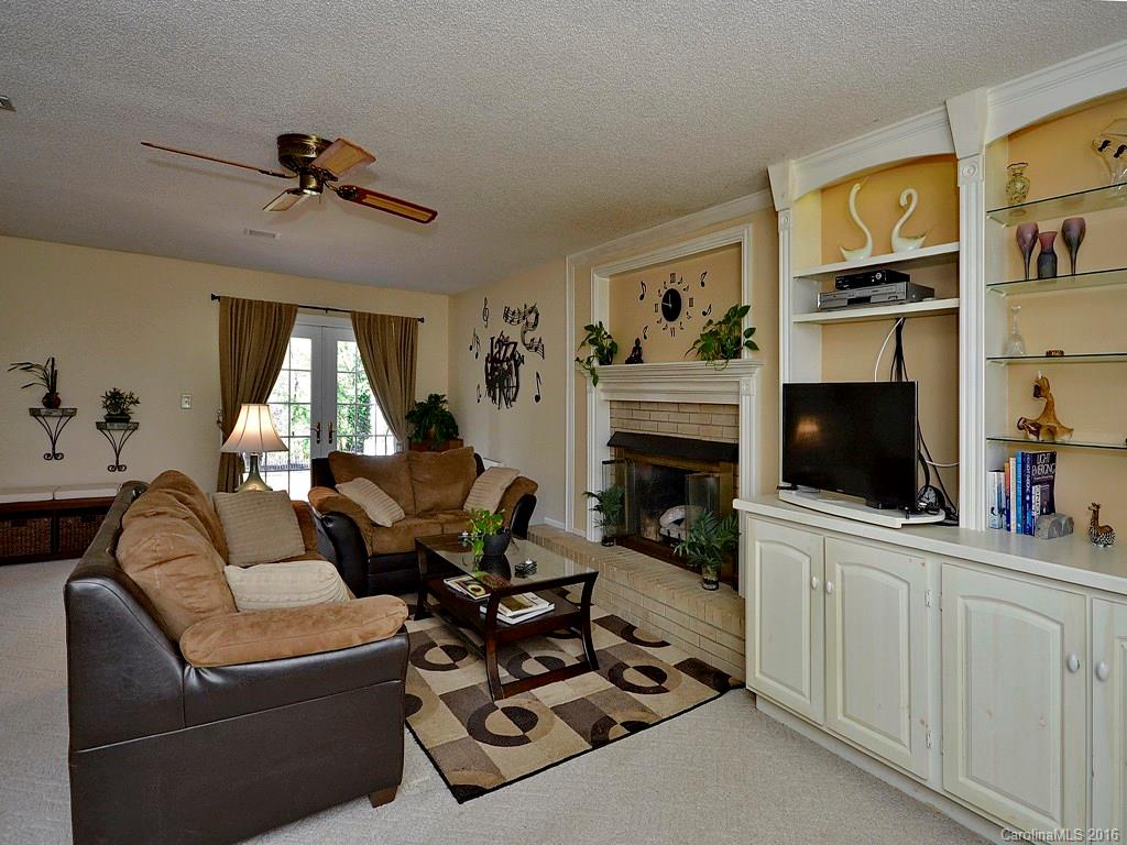 137 Brandon Road Hendersonville, NC 28739 - Photo 14 of 20 a living room with furniture a flat screen tv and a fireplace