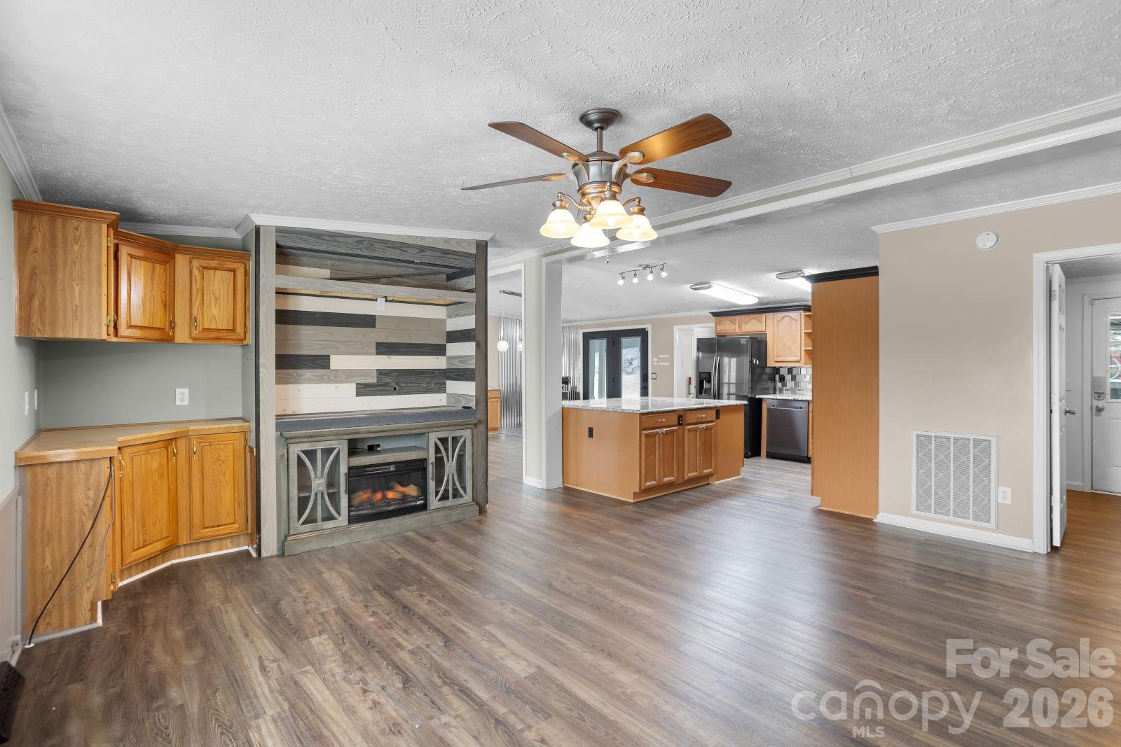4855 Talley Road Walkertown, NC 27051 - Photo 19 of 45 a view of a kitchen with a sink cabinet a kitchen island and a wooden floor