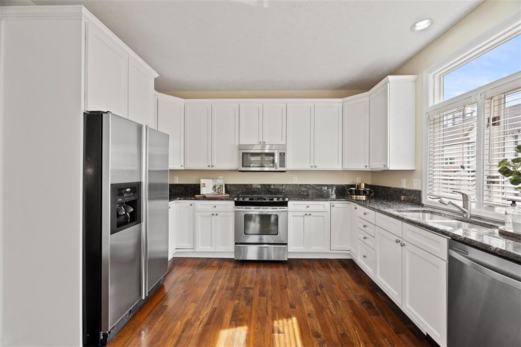 7 Waterside Place Pittsburgh, PA 15222 - Photo 12 of 43 a kitchen with stainless steel appliances granite countertop a stove a sink and a refrigerator