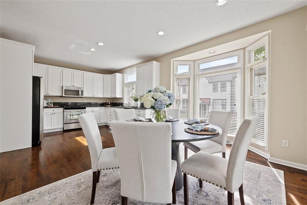 7 Waterside Place Pittsburgh, PA 15222 - Photo 15 of 43 a view of a dining room with furniture a kitchen and chandelier