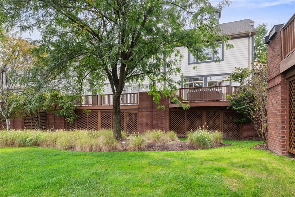 7 Waterside Place Pittsburgh, PA 15222 - Photo 30 of 43 a view of a house next to a lake with a large trees