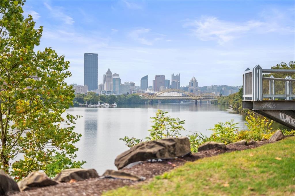 7 Waterside Place Pittsburgh, PA 15222 - Photo 37 of 43 a front view of a house with a lake and trees in the background