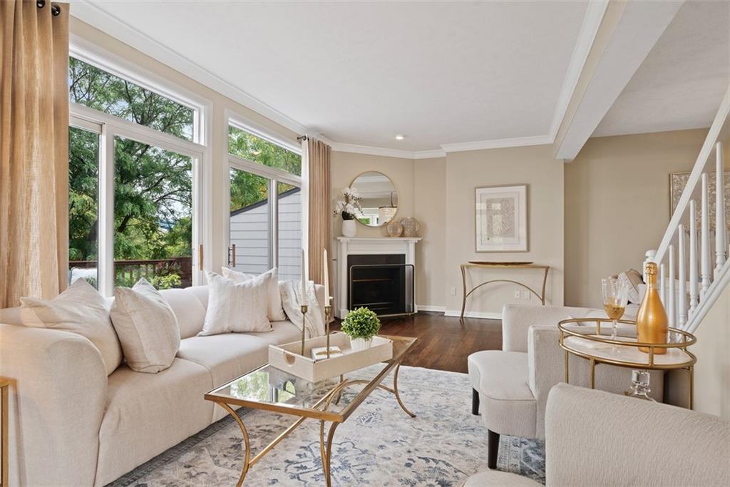 7 Waterside Place Pittsburgh, PA 15222 - Photo 7 of 43 a living room with furniture a fireplace and a large window
