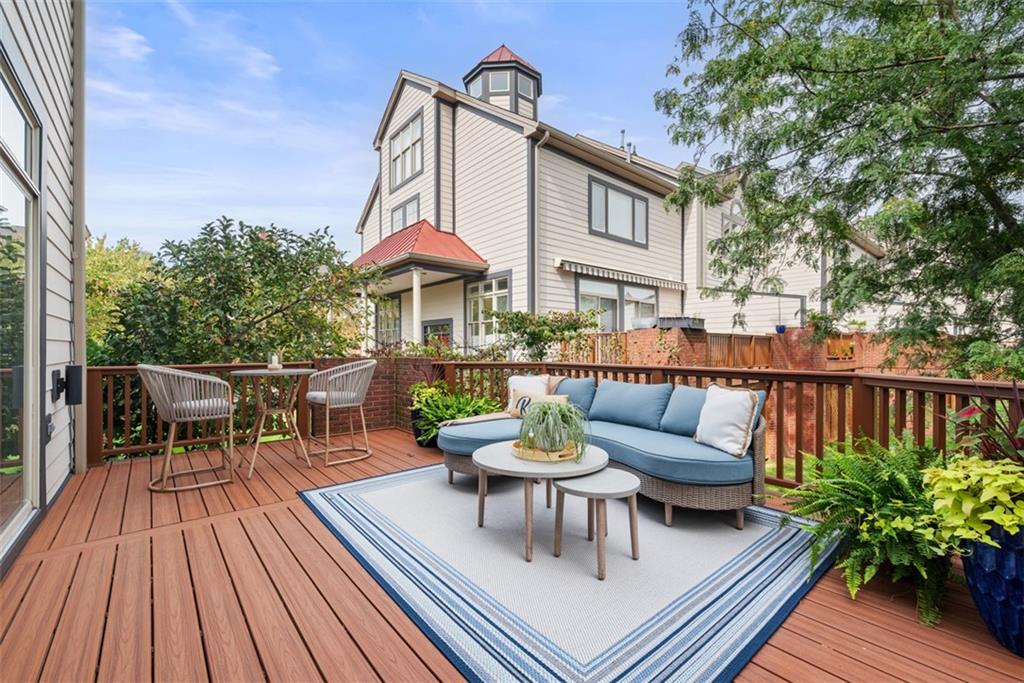 7 Waterside Place Pittsburgh, PA 15222 - Photo 8 of 43 a view of a patio with couches table and chairs with wooden floor and fence
