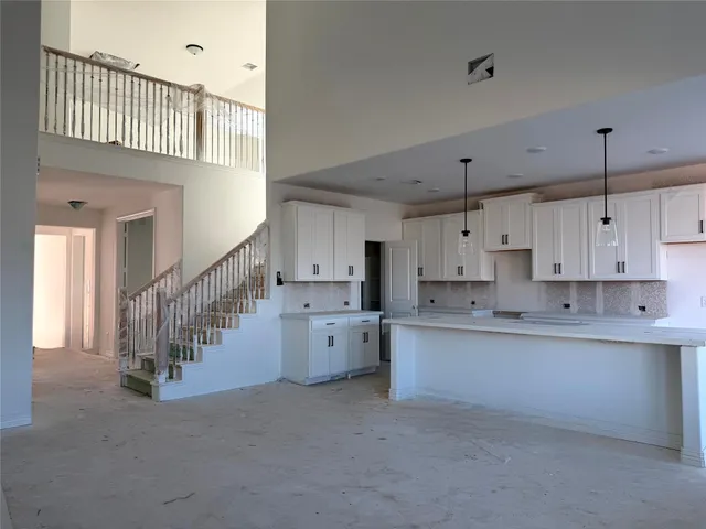 a open kitchen with cabinets a sink a window and stainless steel appliances
