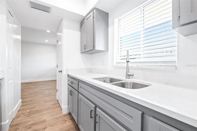 a kitchen with a sink and cabinets