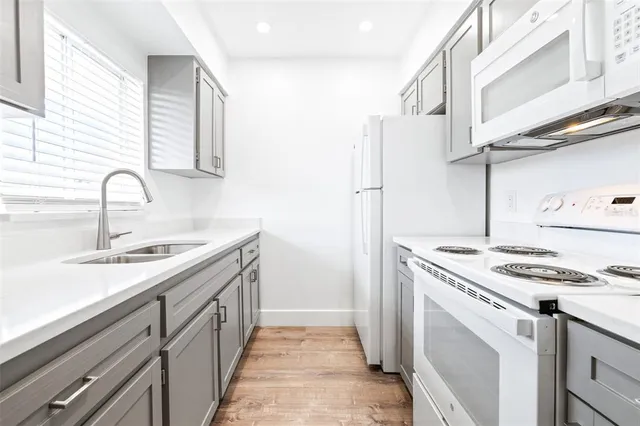 a kitchen with stainless steel appliances granite countertop a sink stove and cabinets
