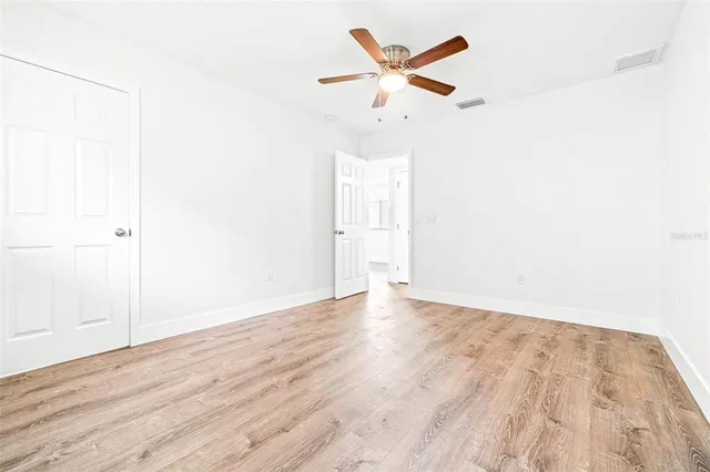 a view of a room with wooden floor and white walls