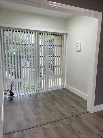 a view of an empty room with wooden floor