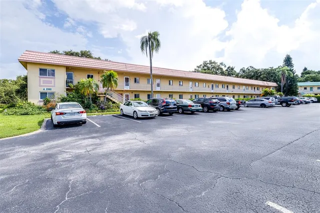 a view of a cars park in front of a building
