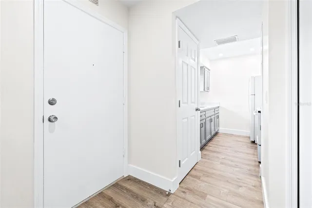 a view of a hallway with wooden floor