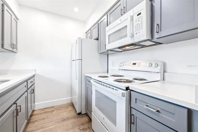 a kitchen with stainless steel appliances granite countertop a stove and a refrigerator