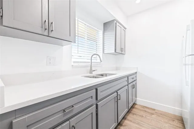 a kitchen with a sink and cabinets