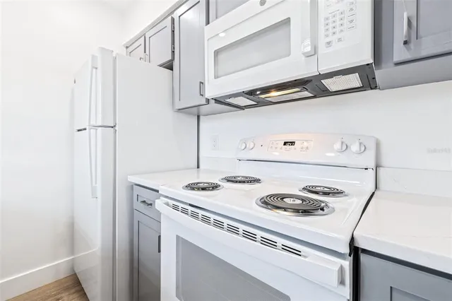 a kitchen with a stove and a white refrigerator