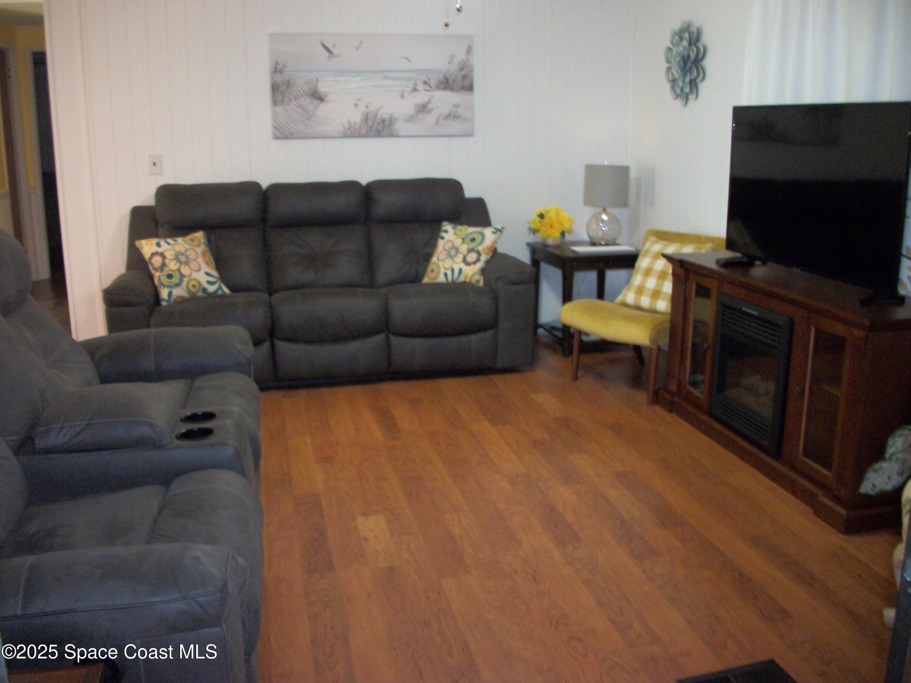 1972 Mango Street Northeast Palm Bay, FL 32905 - Photo 12 of 41 a living room with furniture and a flat screen tv