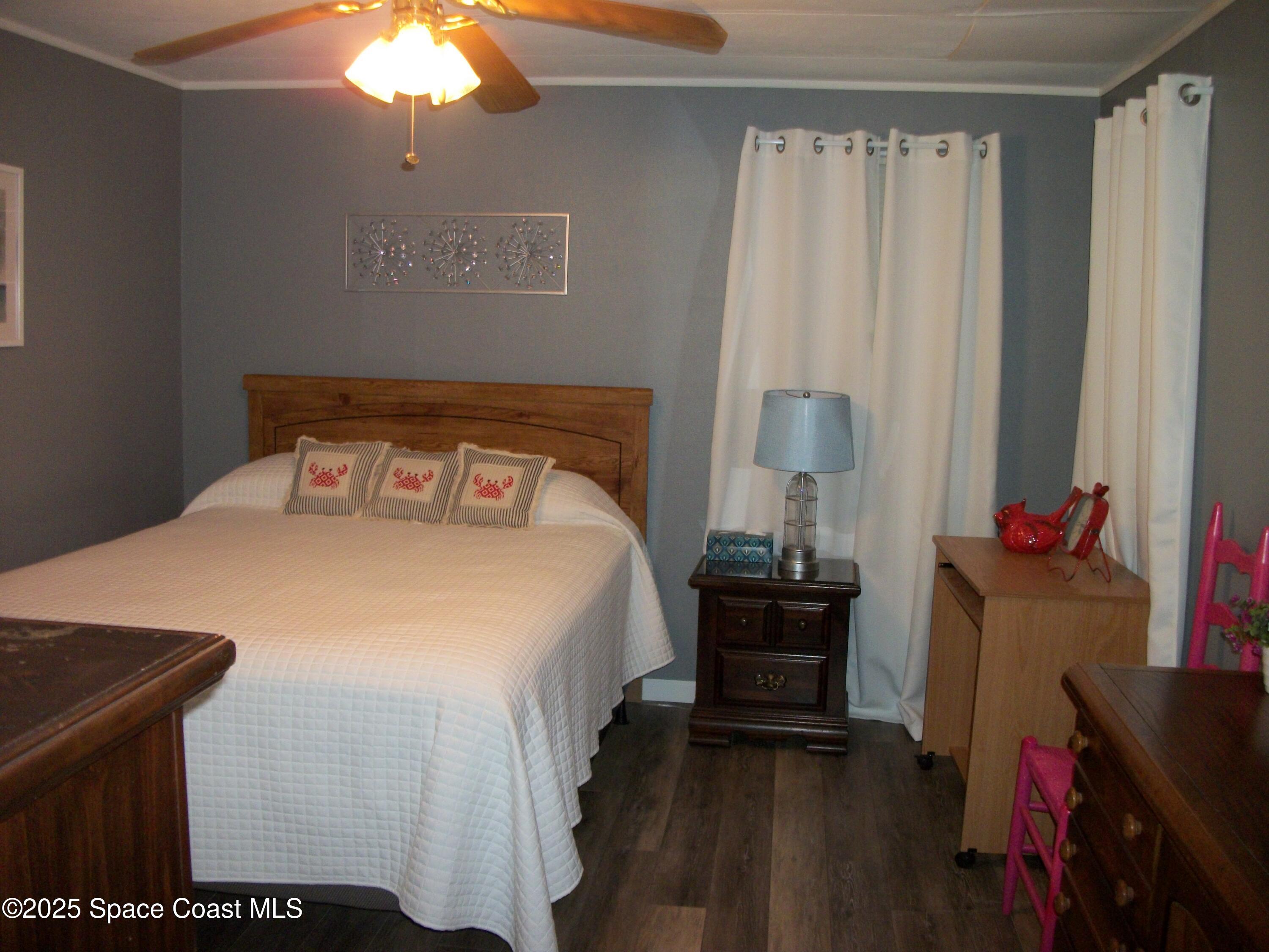 1972 Mango Street Northeast Palm Bay, FL 32905 - Photo 14 of 41 a bedroom with a bed and a chandelier