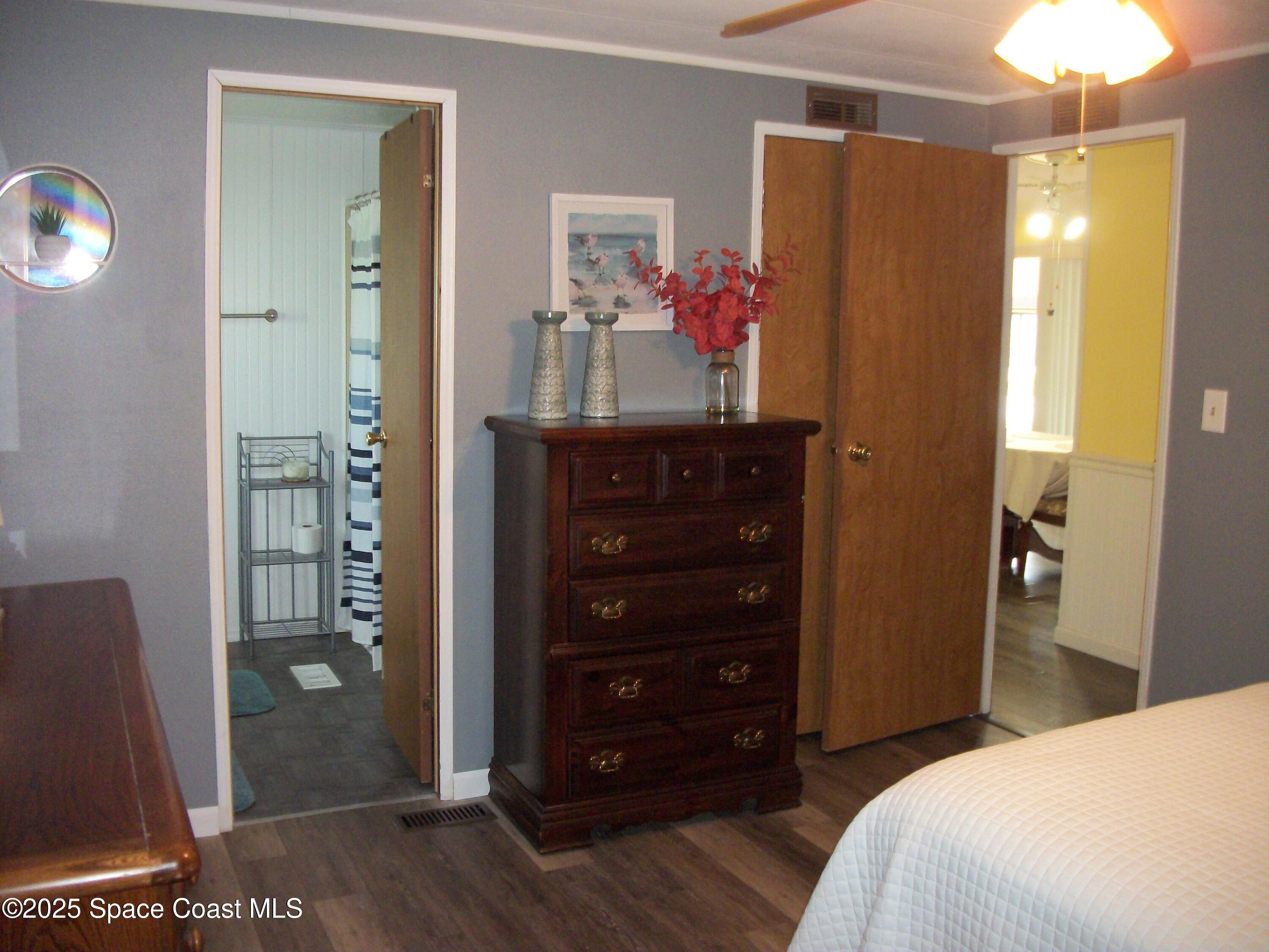 1972 Mango Street Northeast Palm Bay, FL 32905 - Photo 16 of 41 a bedroom with a dresser and a mirror