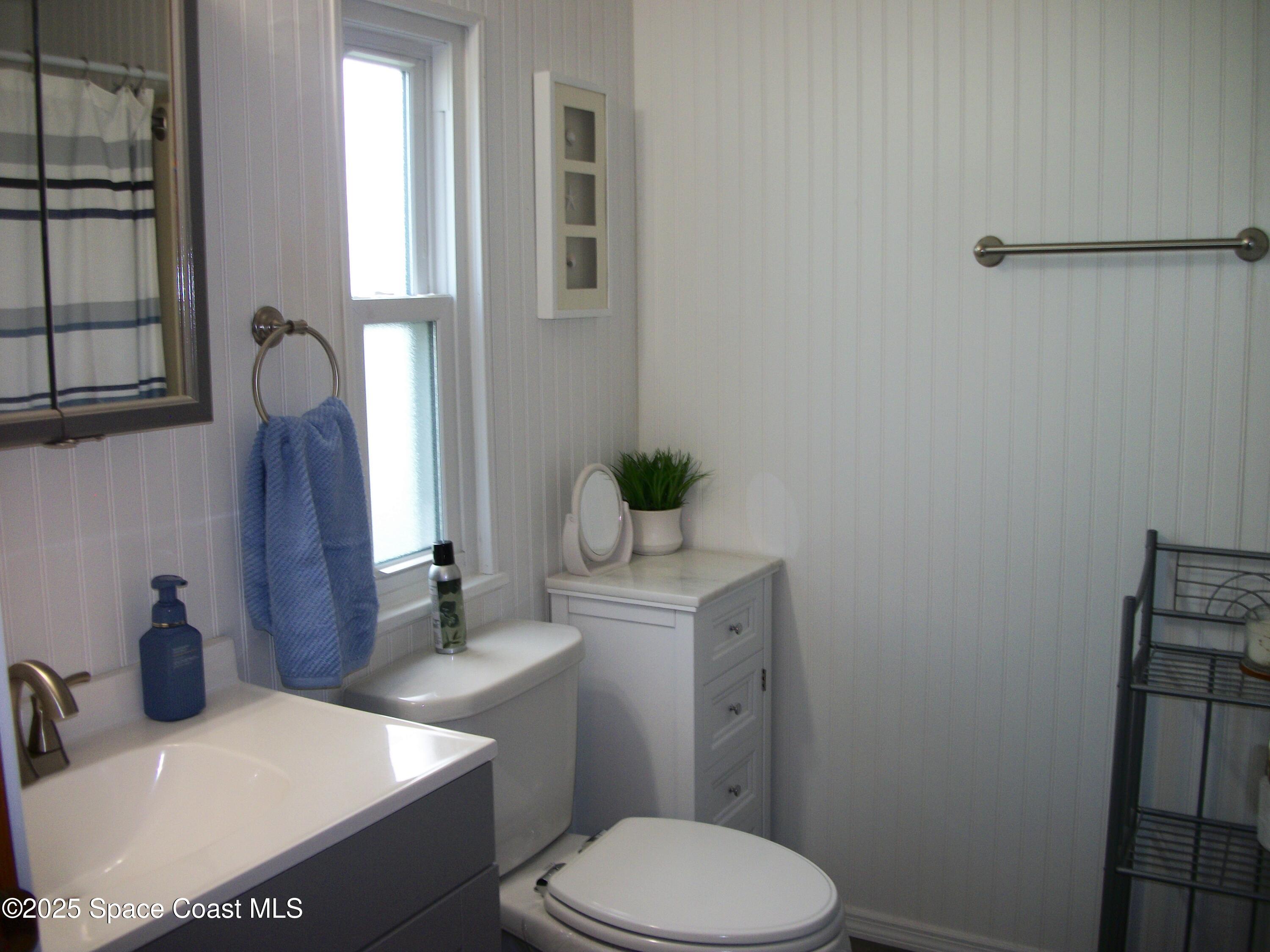 1972 Mango Street Northeast Palm Bay, FL 32905 - Photo 18 of 41 a bathroom with a sink toilet and mirror