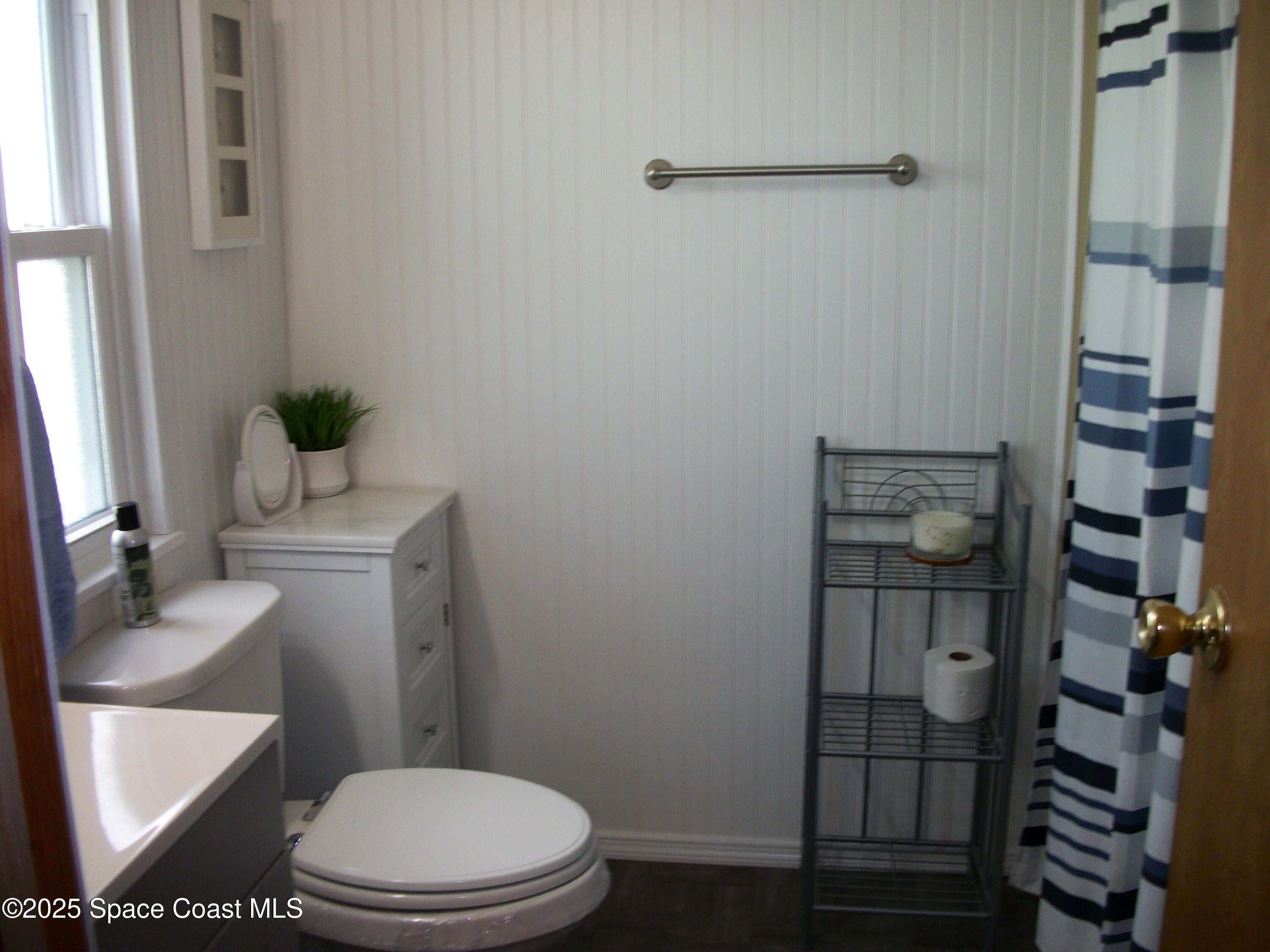 1972 Mango Street Northeast Palm Bay, FL 32905 - Photo 19 of 41 a white toilet sitting next to a bathroom sink