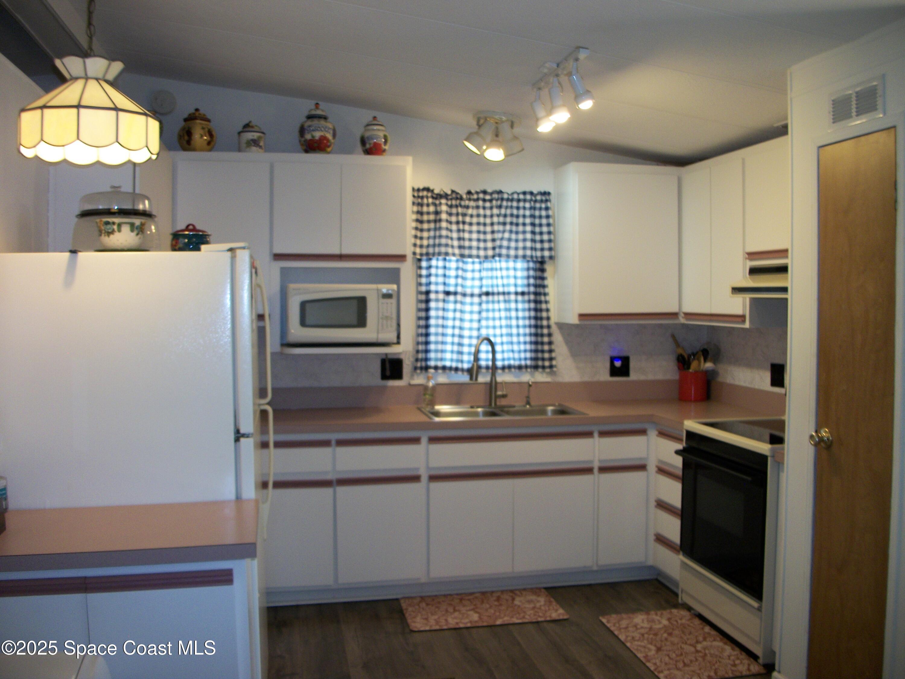 1972 Mango Street Northeast Palm Bay, FL 32905 - Photo 2 of 41 a kitchen with a sink a refrigerator and window