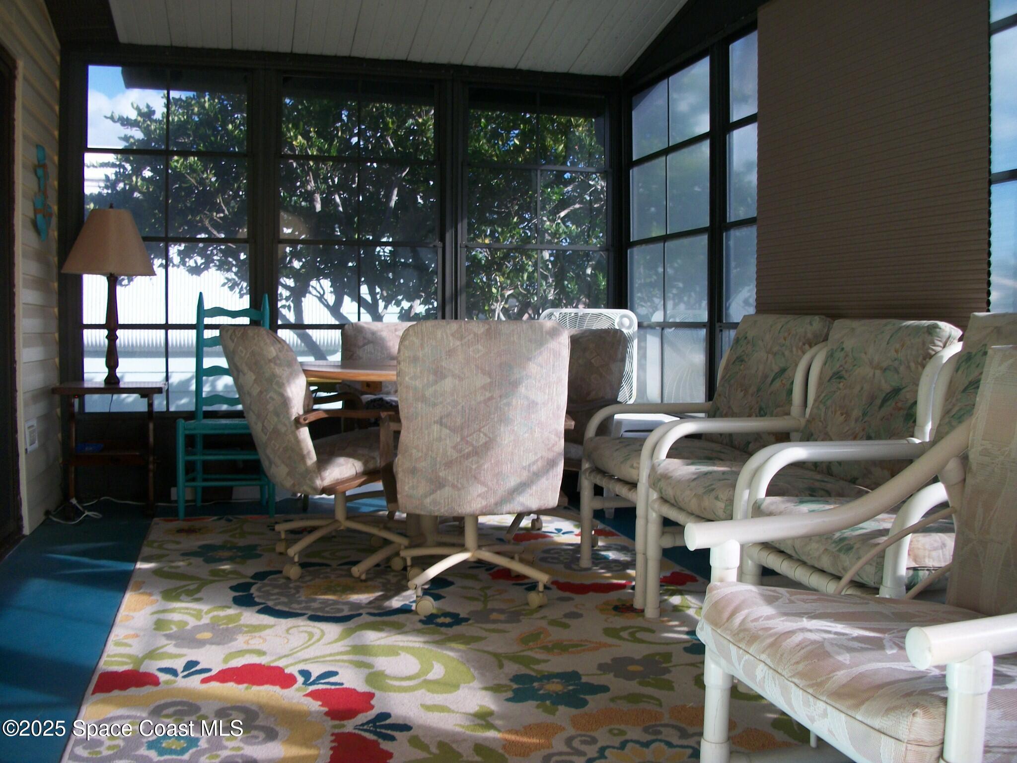 1972 Mango Street Northeast Palm Bay, FL 32905 - Photo 22 of 41 a living room with furniture a rug and a floor to ceiling window