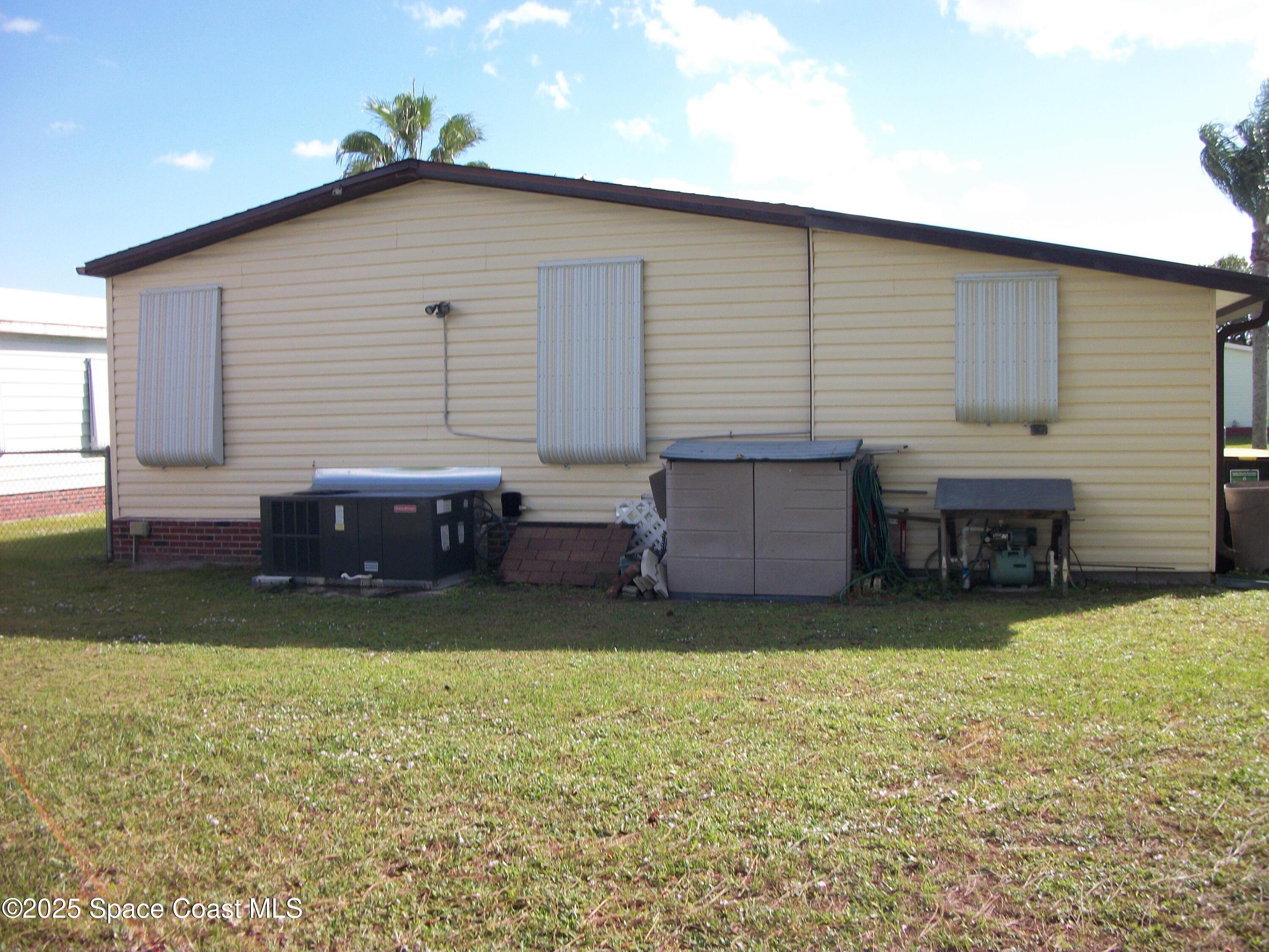1972 Mango Street Northeast Palm Bay, FL 32905 - Photo 27 of 41 a view of a house with a backyard and sitting area