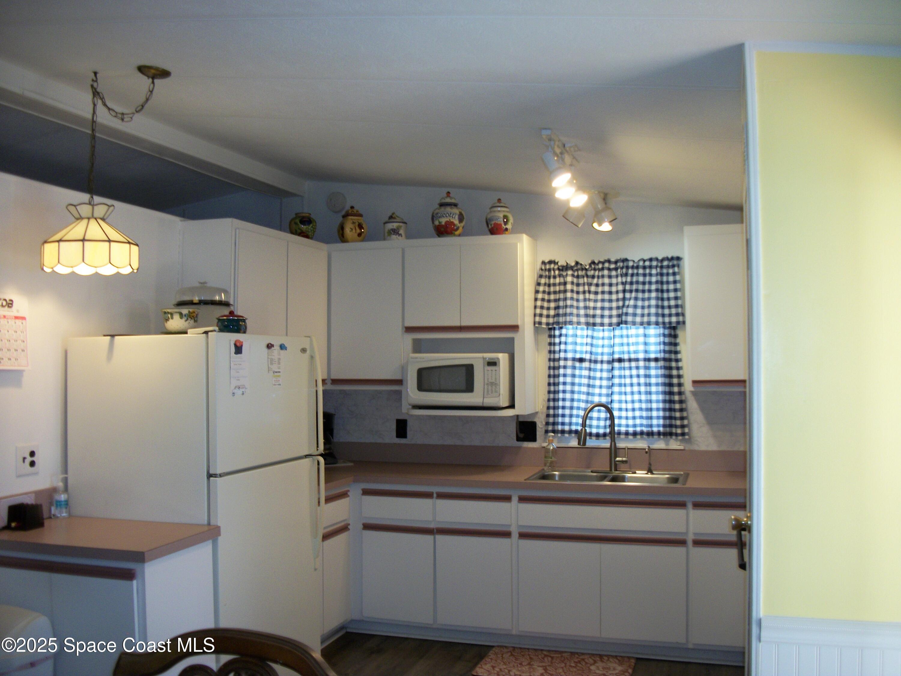 1972 Mango Street Northeast Palm Bay, FL 32905 - Photo 3 of 41 a kitchen with a refrigerator and a stove