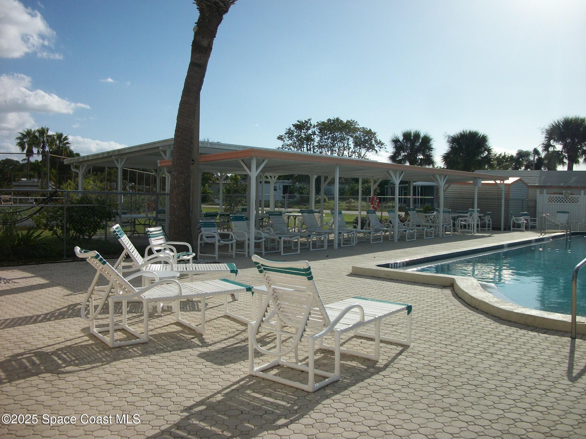 1972 Mango Street Northeast Palm Bay, FL 32905 - Photo 36 of 41 a view of a patio with swimming pool table and chairs