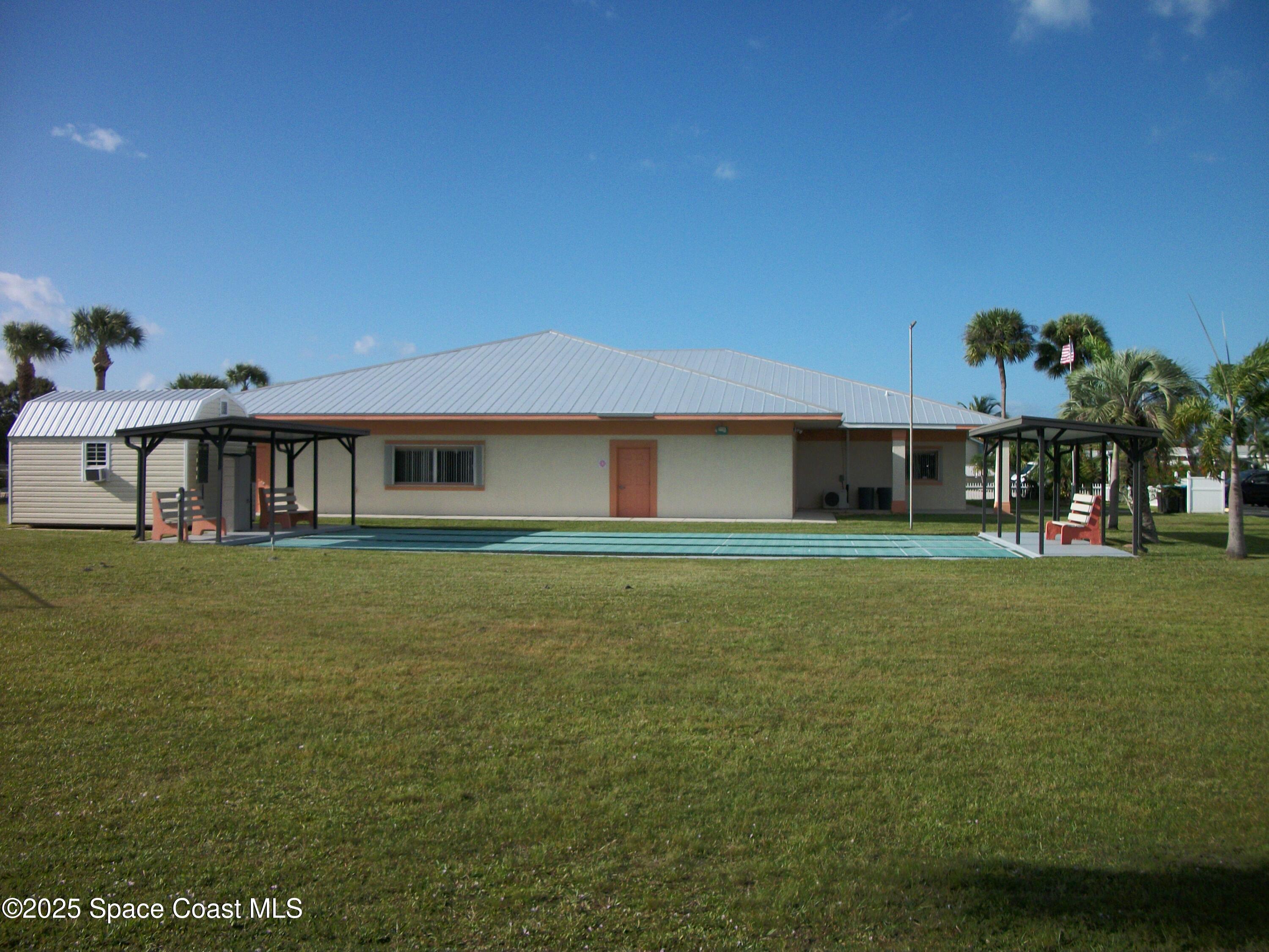 1972 Mango Street Northeast Palm Bay, FL 32905 - Photo 37 of 41 a front view of a house with a garden