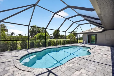 a view of backyard with swimming pool and outdoor seating