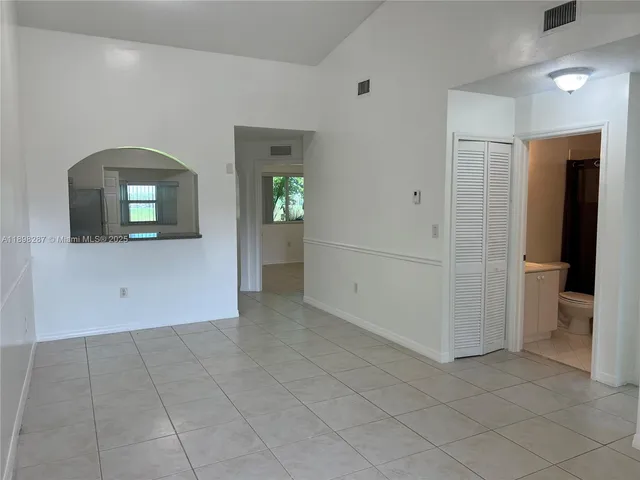 a view of a hallway to rooms and stairs
