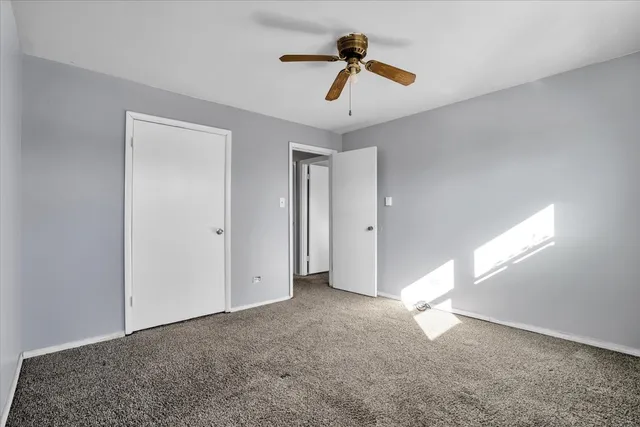 a view of empty room with ceiling fan