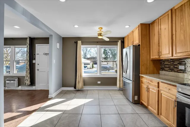a open kitchen with stainless steel appliances granite countertop a refrigerator and a stove top oven