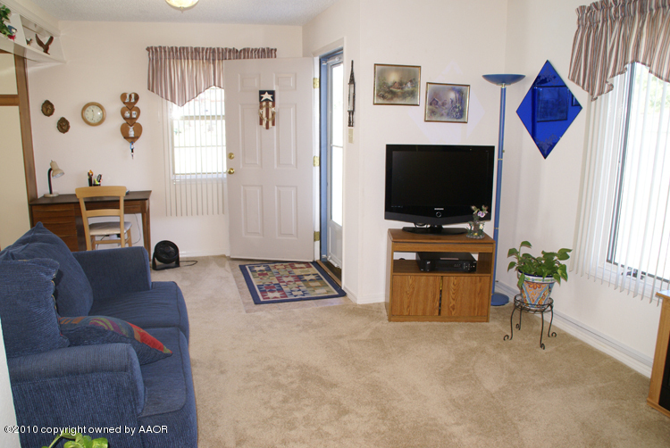 1615 Southwest 48th Avenue Amarillo, TX 79110 - Photo 13 of 14 a living room with furniture and a flat screen tv