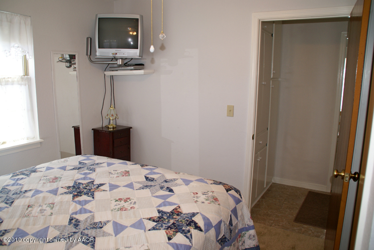 1615 Southwest 48th Avenue Amarillo, TX 79110 - Photo 4 of 14 a bedroom with a bed and a window