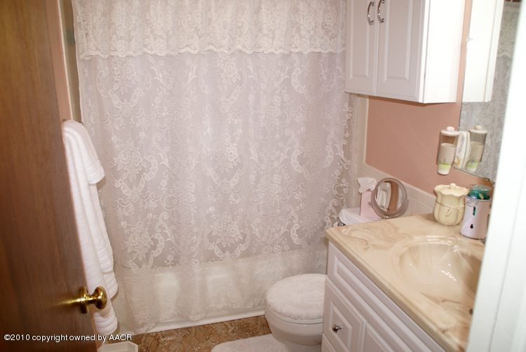 1615 Southwest 48th Avenue Amarillo, TX 79110 - Photo 10 of 14 a bathroom with a granite countertop sink and a toilet