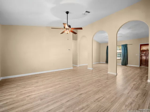 a view of a room with wooden floor