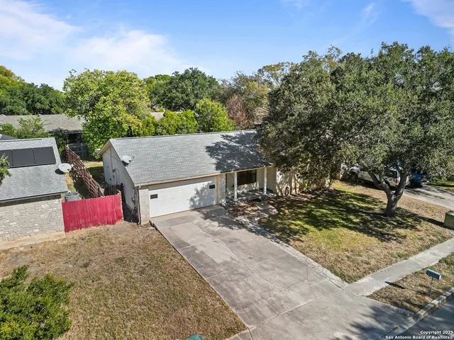 an aerial view of a house with a yard