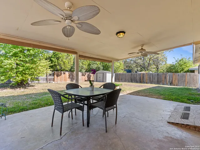 a view of a patio with a table and chairs